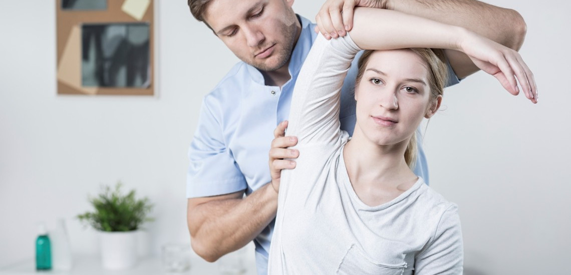 Physiotherapist demonstrating a therapeutic exercise